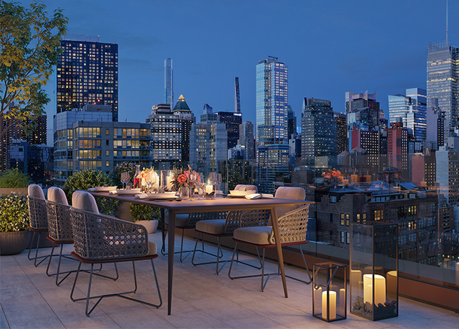 An exterior patio at Coterie Hudson Yards with the Skyline of New York in the background. 