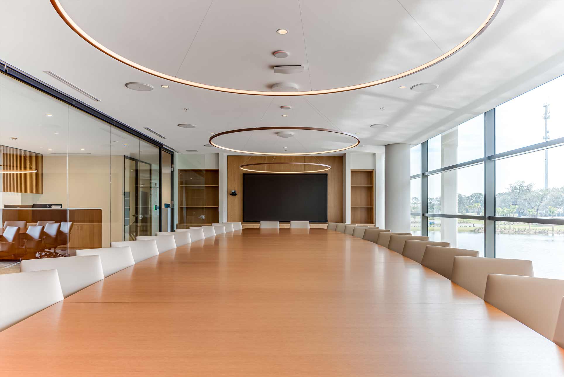 A view from the end of the large wooden conference table.