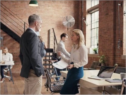 people conversing in an office setting