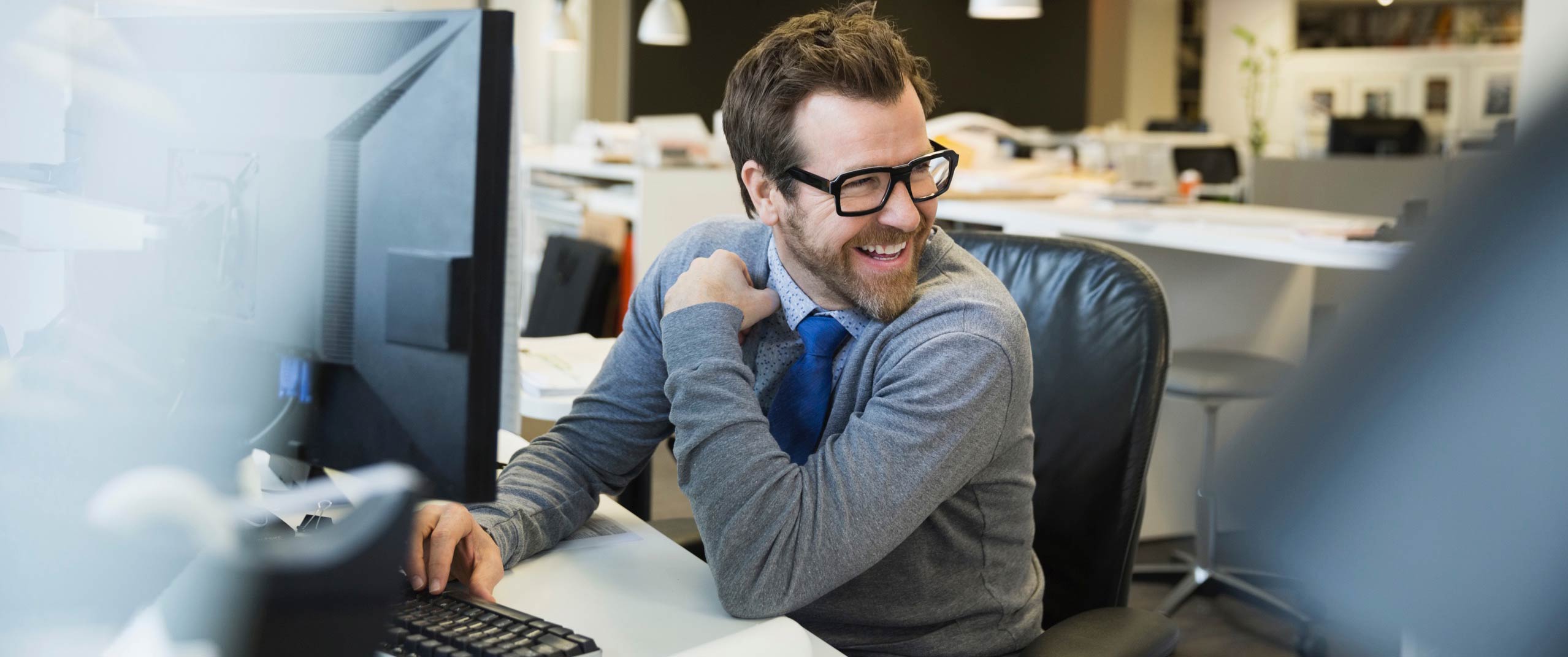 man sitting at desk using human centric lighting