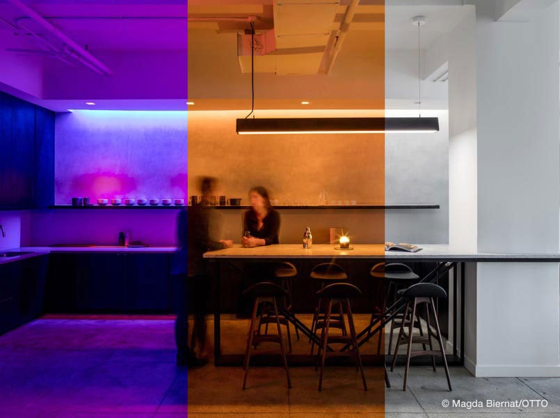 two people in an office kitchen with high quality commercial lighting