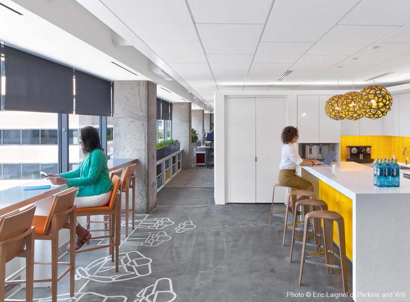 women in an office kitchen with bright and natural lighting